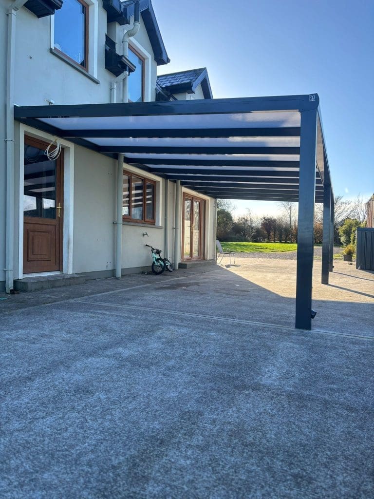 Aluminium pergola with polycarbonate roof providing covered outdoor seating area by Superior Pergola Ireland