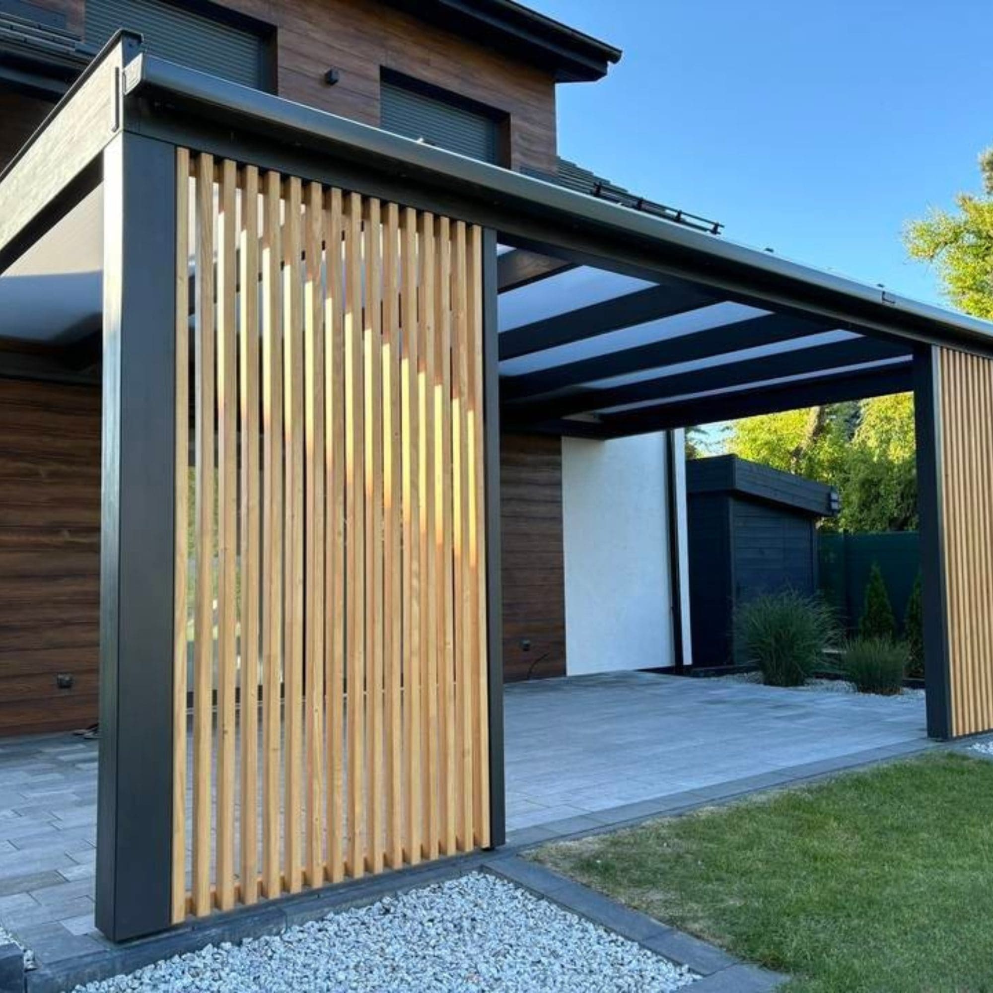 Pergola with vertical slatted privacy screen panels installed in modern garden by Superior Pergola Ireland