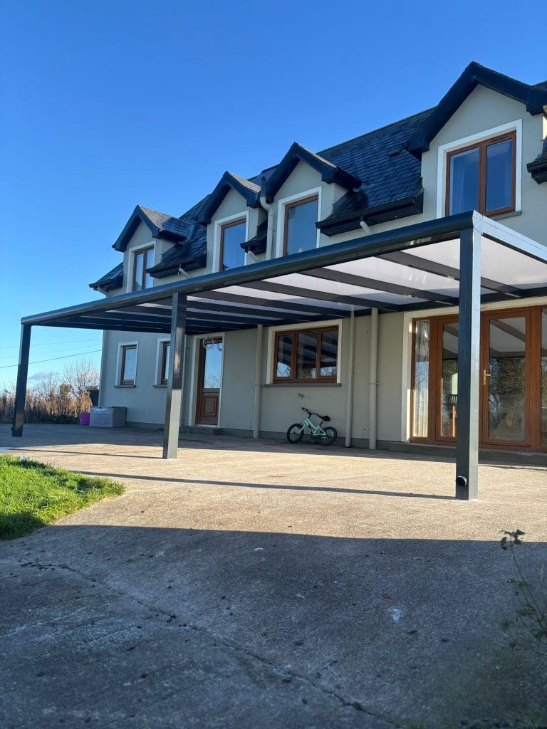 Aluminium pergola with polycarbonate roof providing covered outdoor seating area by Superior Pergola Ireland