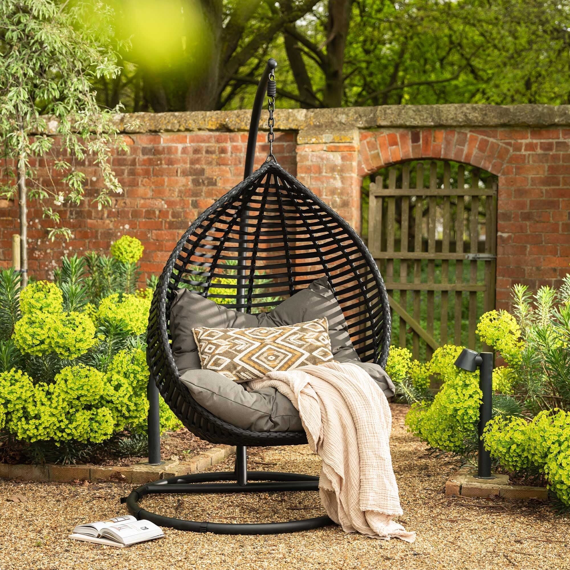 Outdoor egg chair placed under pergola creating a cosy garden seating area by Superior Pergola Ireland