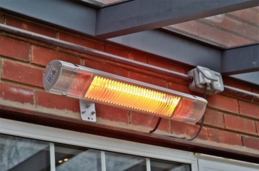 Outdoor patio heater installed under aluminium pergola for year round garden use by Superior Pergola Ireland
